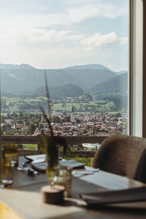 Gedeckter Tisch am Panoramafenster mit Blick über Oberstdorf